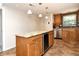 Kitchen island with granite countertops, storage cabinets and a wine cooler, seamlessly integrated with stainless appliances at 3985 Maceachen Blvd # 224, Sarasota, FL 34233
