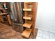 Pantry with pull-out shelves next to the stainless-steel refrigerator in the updated kitchen at 3985 Maceachen Blvd # 224, Sarasota, FL 34233