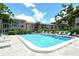 A sparkling pool with lounge chairs surrounded by lush landscaping at this lovely condo community at 3985 Maceachen Blvd # 224, Sarasota, FL 34233