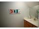 Stylish half bathroom with a modern vanity, decorative mirror, and unique coastal decor at 4026 Overture Cir # 487, Bradenton, FL 34209