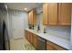 Functional kitchen featuring bright countertops, wood cabinets, stainless dishwasher, and a double sink at 4026 Overture Cir # 487, Bradenton, FL 34209