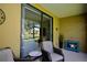 Relaxing patio area with wicker furniture, providing a peaceful outdoor retreat with a view of the lush surroundings at 4026 Overture Cir # 487, Bradenton, FL 34209