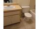 Bathroom features a toilet, vanity with sink and cabinets with a tiled floor at 4154 Center Pointe Cir # 57A, Sarasota, FL 34233