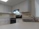 This eat-in kitchen features stainless steel appliances, white cabinets and light countertops at 4154 Center Pointe Cir # 57A, Sarasota, FL 34233