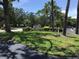 Community sign with well-manicured landscaping and mature trees, offering a welcoming atmosphere at 5178 Lake Village Drive # 86, Sarasota, FL 34235