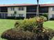 Building exterior showcasing the screened lanai and the lush landscaping at 5178 Lake Village Drive # 86, Sarasota, FL 34235