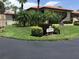 Beautiful condo community featuring lush landscaping, palm trees, and a meticulously maintained lawn at 5178 Lake Village Drive # 86, Sarasota, FL 34235