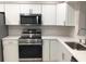 This kitchen features stainless steel appliances, sleek white cabinetry, and stylish countertops at 5178 Lake Village Drive # 86, Sarasota, FL 34235