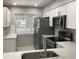 Updated kitchen features stainless steel appliances, white cabinets, and bright natural light at 5178 Lake Village Drive # 86, Sarasota, FL 34235