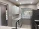 Updated kitchen with stainless steel appliances, white cabinets, tile backsplash, and plenty of counter space at 5178 Lake Village Drive # 86, Sarasota, FL 34235