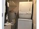 Functional laundry area with stacked washer and dryer next to the water heater at 5178 Lake Village Drive # 86, Sarasota, FL 34235