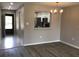 Living room with view to the kitchen featuring stainless steel appliances and ample natural light at 5178 Lake Village Drive # 86, Sarasota, FL 34235