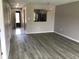 Open-concept living room showcasing light wood flooring, natural lighting, and an open entryway at 5178 Lake Village Drive # 86, Sarasota, FL 34235