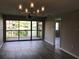 Spacious living room with wood-look floors and sliding glass doors to the screened-in lanai at 5178 Lake Village Drive # 86, Sarasota, FL 34235