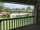 Screened lanai view of the pool surrounded by lush landscaping and manicured lawns at 5178 Lake Village Drive # 86, Sarasota, FL 34235