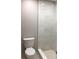 Modern tiled walk-in shower with bench seating at 5178 Lake Village Drive # 86, Sarasota, FL 34235