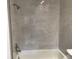 White tiled shower, featuring modern showerhead and faucet fixtures at 5178 Lake Village Drive # 86, Sarasota, FL 34235