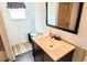 Bathroom featuring a vanity with a countertop, a mirror, and a bathtub with a shower at 5233 Kenwood Ave, Sarasota, FL 34234
