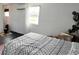 Bright bedroom featuring dark wood floor, black metal frame bed, and a window with natural light at 5233 Kenwood Ave, Sarasota, FL 34234
