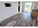 Empty room with wood look floors, sliding door and window at 5233 Kenwood Ave, Sarasota, FL 34234