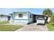 Charming single-story home with a well-maintained lawn, driveway, and mature landscaping at 5233 Kenwood Ave, Sarasota, FL 34234