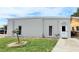 Exterior view of the community fitness room, featuring well-maintained landscaping and accessible entryway at 5233 Kenwood Ave, Sarasota, FL 34234