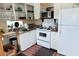 Bright kitchen features white appliances, sink with window, and charming decor at 5233 Kenwood Ave, Sarasota, FL 34234