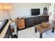 Living room with television, cabinets, decor and comfortable seating at 5233 Kenwood Ave, Sarasota, FL 34234