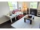 Inviting living room with fireplace, plush white rug, and comfortable seating area at 5233 Kenwood Ave, Sarasota, FL 34234