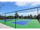 Outdoor pickleball courts feature vibrant green and blue surfaces, enclosed by a secure black fence at 5233 Kenwood Ave, Sarasota, FL 34234