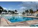 A large, clear swimming pool surrounded by palm trees and lounge chairs offers a relaxing environment at 5233 Kenwood Ave, Sarasota, FL 34234