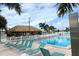 Poolside tiki bar with several lounge chairs, perfect for entertaining and relaxation at 5233 Kenwood Ave, Sarasota, FL 34234