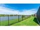 Iron fenced backyard with manicured lawn and pond views at 5327 Olano St, Palmetto, FL 34221