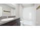 Bright bathroom features a granite countertop vanity, framed mirror, and shower-tub combo at 5327 Olano St, Palmetto, FL 34221