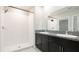 Full bathroom featuring a dual sink vanity with granite countertops and a walk-in shower at 5327 Olano St, Palmetto, FL 34221