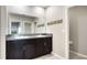 Bathroom featuring dual sinks with granite countertops and a decorative wooden accent piece at 5327 Olano St, Palmetto, FL 34221