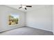 Bedroom with a large window overlooking a lawn with trees and plants, plus a ceiling fan at 5327 Olano St, Palmetto, FL 34221