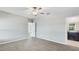 A light, bright bedroom with a ceiling fan and a door leading into the en suite bathroom at 5327 Olano St, Palmetto, FL 34221