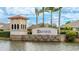 Elegant community entrance with Trevesta signage, stone base, and tile-roofed structure, surrounded by palm trees and water feature at 5327 Olano St, Palmetto, FL 34221