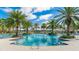 Gorgeous resort-style community pool surrounded by lush palm trees, comfortable lounge chairs, and shaded cabanas at 5327 Olano St, Palmetto, FL 34221
