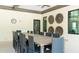Elegant dining area with a large wooden table, comfortable chairs, and stylish decor for community gatherings and events at 5327 Olano St, Palmetto, FL 34221
