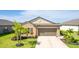 Charming single-story home with a two-car garage, a well-kept lawn, and tropical landscaping at 5327 Olano St, Palmetto, FL 34221