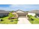 Inviting single-story home showcasing a manicured lawn, vibrant landscaping, and an attached two-car garage at 5327 Olano St, Palmetto, FL 34221