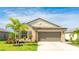 Charming single-story home with a well-manicured lawn, landscaping and a two car garage at 5327 Olano St, Palmetto, FL 34221