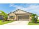 Charming single-story home with a well-manicured lawn, landscaping and a two car garage at 5327 Olano St, Palmetto, FL 34221