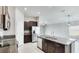 Modern kitchen showcasing granite countertops, stainless steel appliances, dark cabinetry, and an open layout at 5327 Olano St, Palmetto, FL 34221