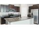 Modern kitchen featuring granite countertops, stainless steel appliances, and dark wood cabinetry for a luxurious feel at 5327 Olano St, Palmetto, FL 34221