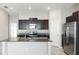 Modern open-concept kitchen with granite countertops, stainless steel appliances, and dark cabinets at 5327 Olano St, Palmetto, FL 34221