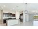 Open kitchen with granite countertops, stainless steel appliances, and seamlessly connects to the living area at 5327 Olano St, Palmetto, FL 34221