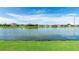 Scenic lake view showcasing the neighborhood homes with vibrant green grass, creating a peaceful waterfront community setting at 5327 Olano St, Palmetto, FL 34221